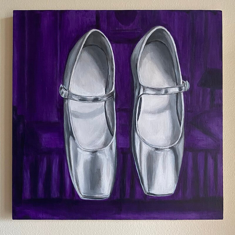 Dressed in black satin with a string of pearls